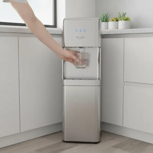 Whirlpool self-cleaning bottom load water dispenser in a modern kitchen with a glass of water being filled.